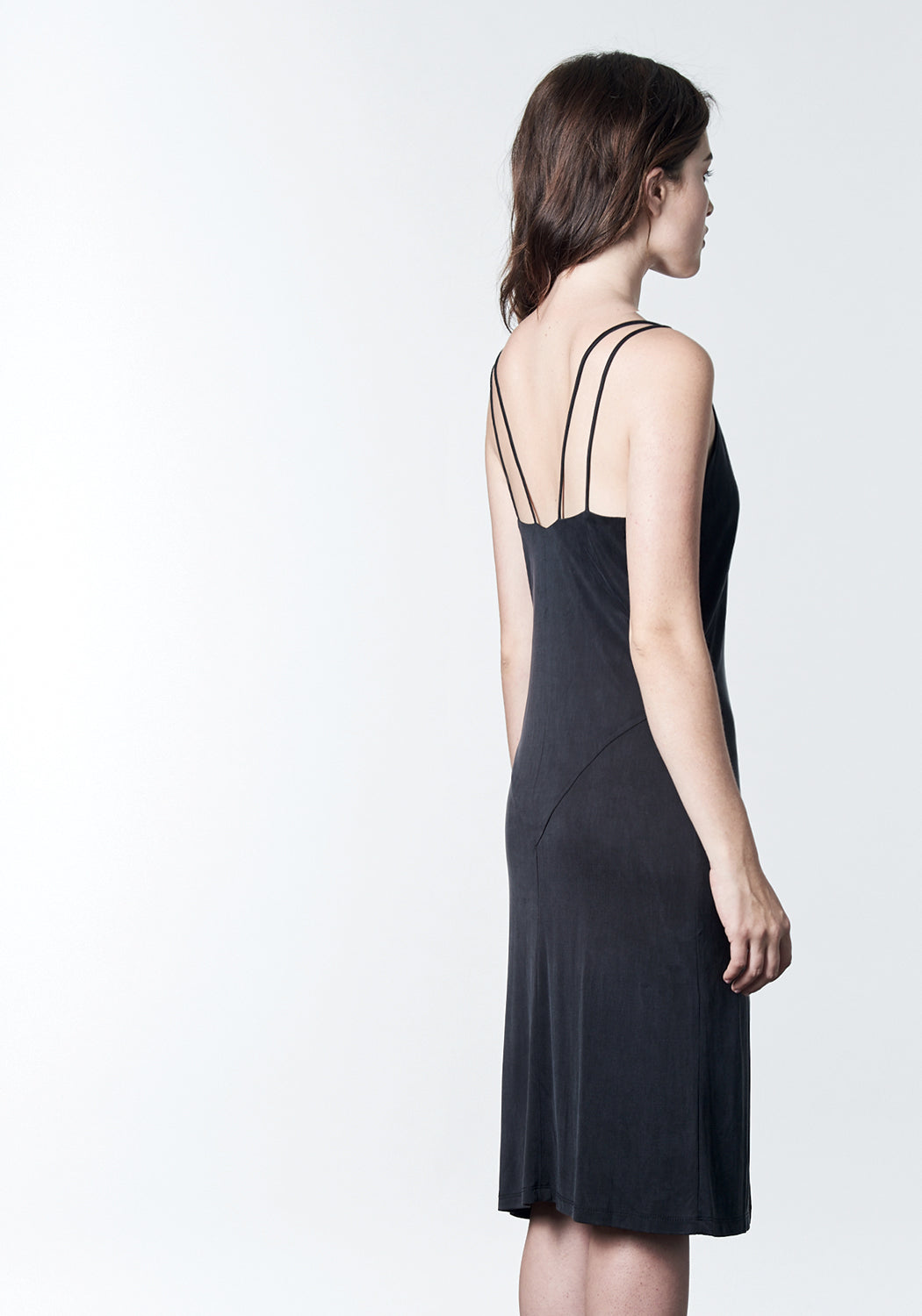 Soft black, midi-length, slip dress with slit.