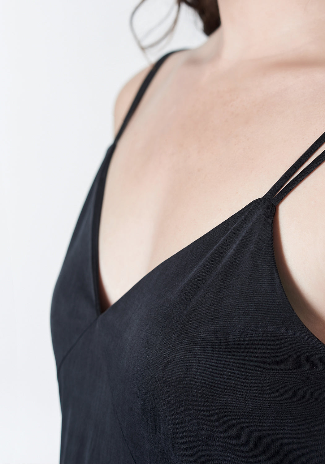 Soft black, midi-length, slip dress with slit.