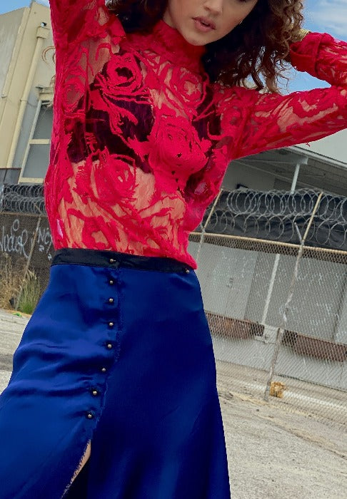 woman's hot pink lace and embroidered top with cobalt blue skirt